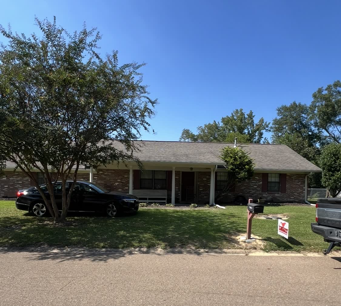 Brick rancher with completed siding and trim work in Central Mississippi